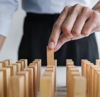 Woman lining up wooden dominoes